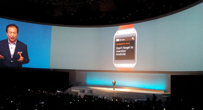 Samsung Mobile head JK Shin receives a notification from his Galaxy Gear smartwatch during the Samsung Unpacked event in Berlin