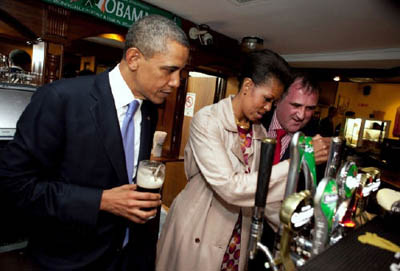 US President Barack Obama and First Lady Michelle Obama take a sip of Guiness in Monegall, Ireland on 23 May 2011