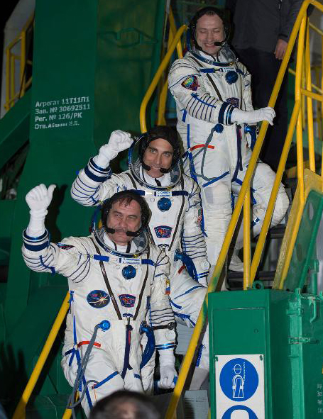 The Expedition 35 crew pictured waving farewell yesterday from the base of the Soyuz rocket at the Baikonur Cosmodrome in Baikonur, Kazakhstan. From top: Russian flight engineer Alexander Misurkin, NASA flight engineer Chris Cassidy and Soyuz commander Pavel Vinogradov. Photo Credit: NASA/Carla Cioffi