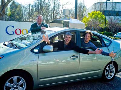 Eric Schmidt, executive chairman; Google; Larry Page, CEO, and Sergey Brin, co-founder, in the Google self-driving hybrid car