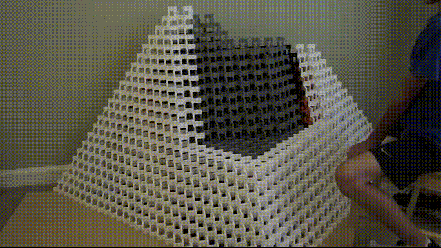 Crumbling domino pyramid GIF