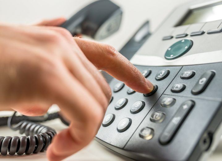 Close-up of male hand dialling a phone number making a business or personal phone call.