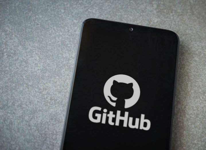 A smartphone displaying the GitHub logo on its screen.