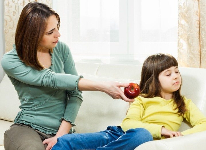 rejectedappleproducts: Girl refusing to take apple from mother