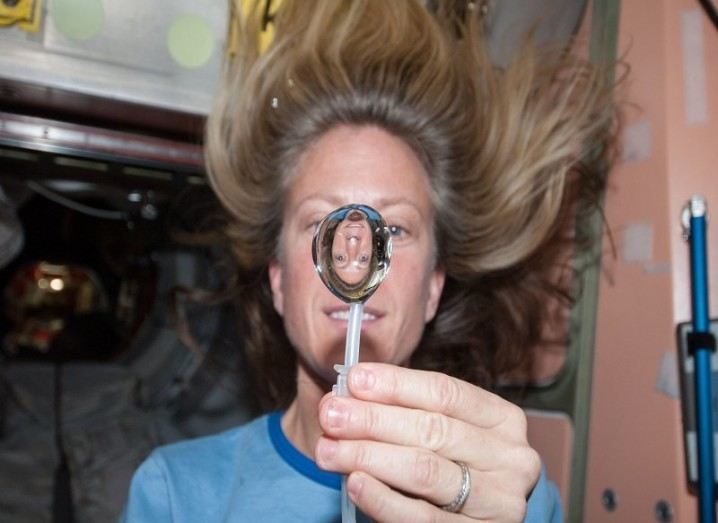 NASA astronaut recruitment: NASA astronaut Karen Nyberg, squeezes a water bubble out of her beverage container, showing her image refracted