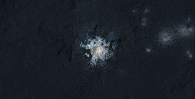 Occator Crater is 92km wide, with a central pit around 10km wide. This enhanced-color view highlights subtle color differences on Ceres' surface, via NASA/JPL-Caltech/UCLA/MPS/DLR/IDA/PSI/LPI