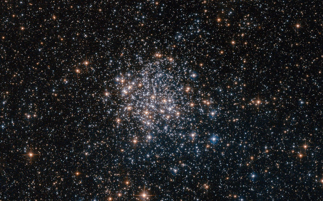 Star cluster NGC 1854, a gathering of red, white and blue stars in the southern constellation of Dorado (The Dolphinfish). NGC 1854 is located about 135,000 light-years away in the Large Magellanic Cloud (LMC), one of our closest cosmic neighbors and a satellite galaxy of the Milky Way. Image via ESA/Hubble/NASA