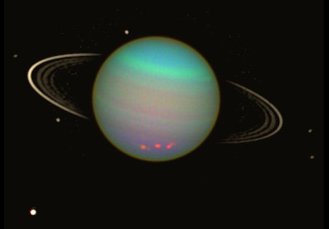 Uranus is seen in this false-color view from NASA's Hubble Space Telescope from August 2003. The brightness of the planet's faint rings and dark moons has been enhanced for visibility. Image: NASA/Erich Karkoschka (Univ. Arizona)