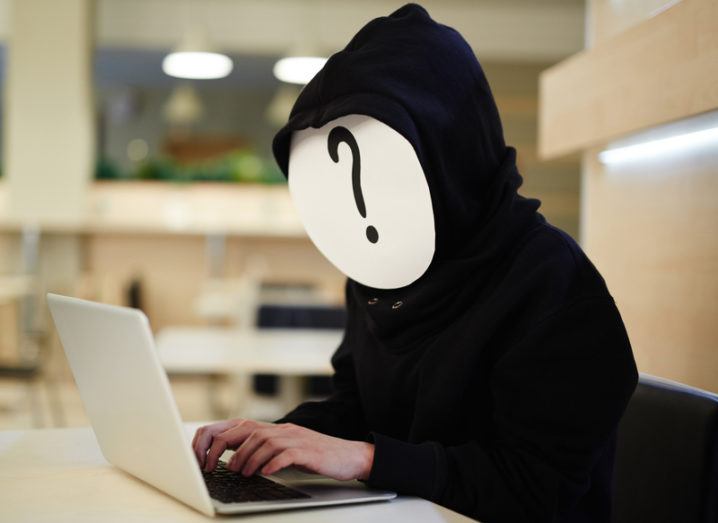 Man hiding face from laptop
