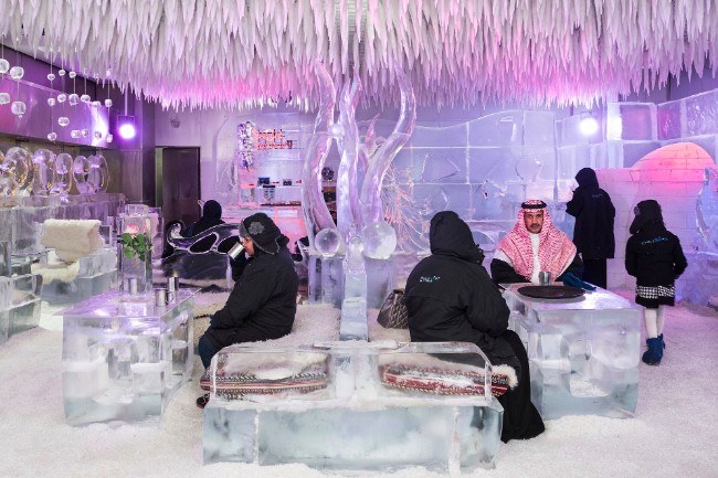 Chillout Ice Lounge, Dubai, January 2016. Saudi tourists having a hot chocolate at the Chillout Ice Lounge, the first ice lounge in the Middle East, with ice sculptures, ice seating and tables, all at a subzero temperature. Image: Nick Hannes, Documentary Series Winner, Magnum and LensCulture Photography Awards 2017.