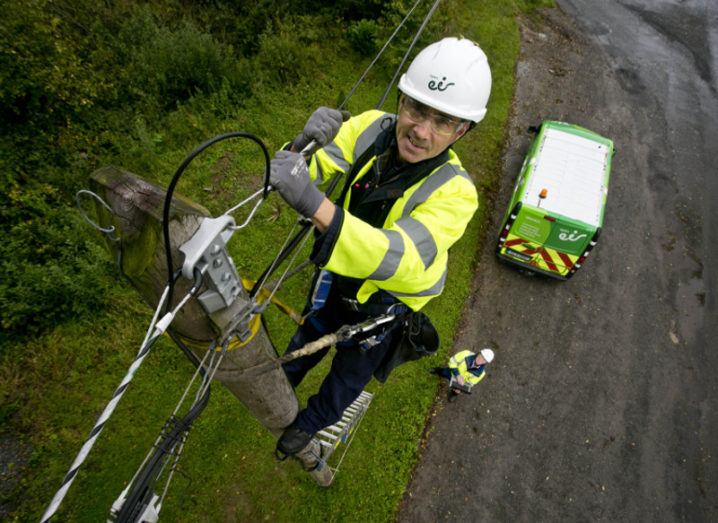 Engineer from Eir climbing a pole.