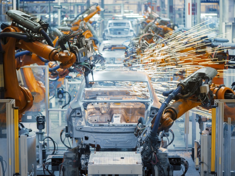 Robots working in a factory producing cars