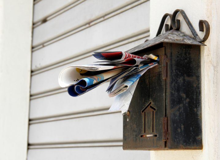 a postbox stuffed with junk mail