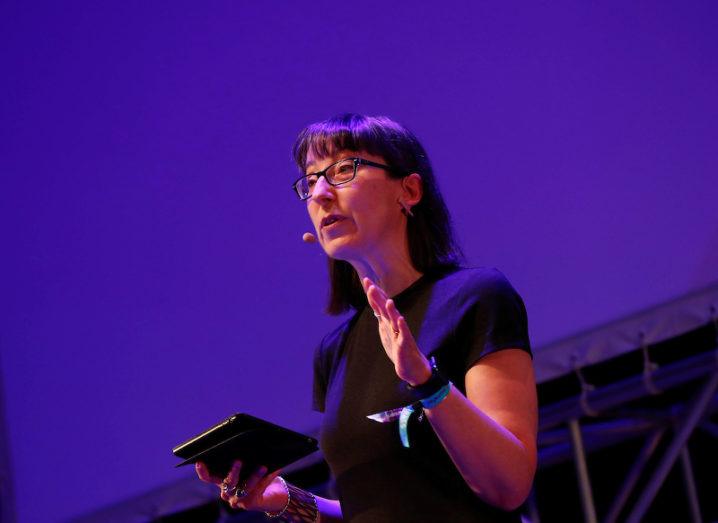 Ann O'Dea, holding an iPad, opens proceedings on the Inspirefest 2018 stage