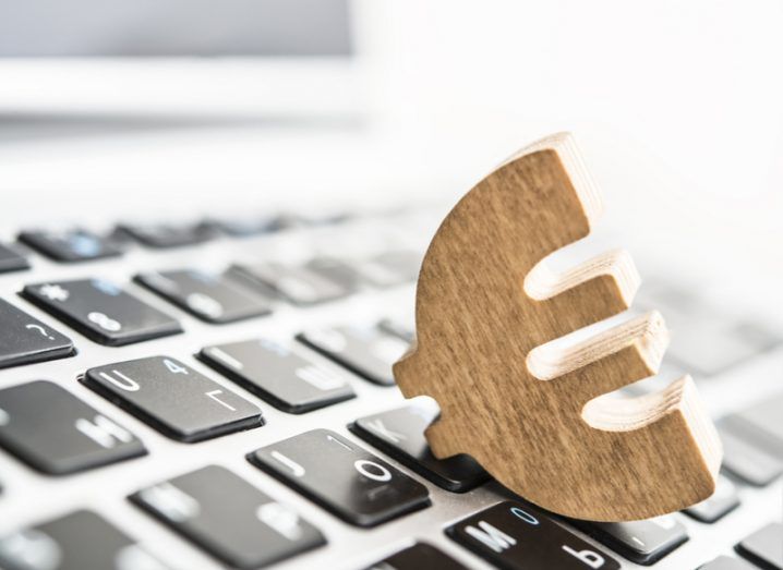 Image of a wooden euro symbol on a computer keyboard