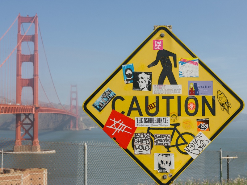 Golden Gate Bridge in background with Caution sign in foreground