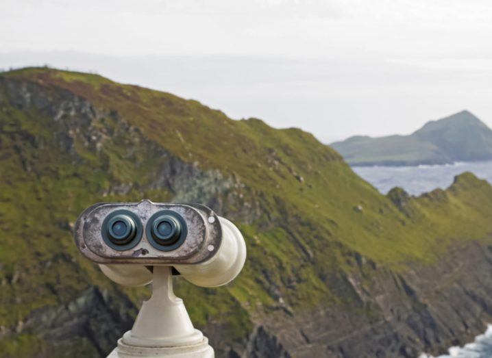 Old tourist telescope on the Irish atlantic coast, view on the cliffs