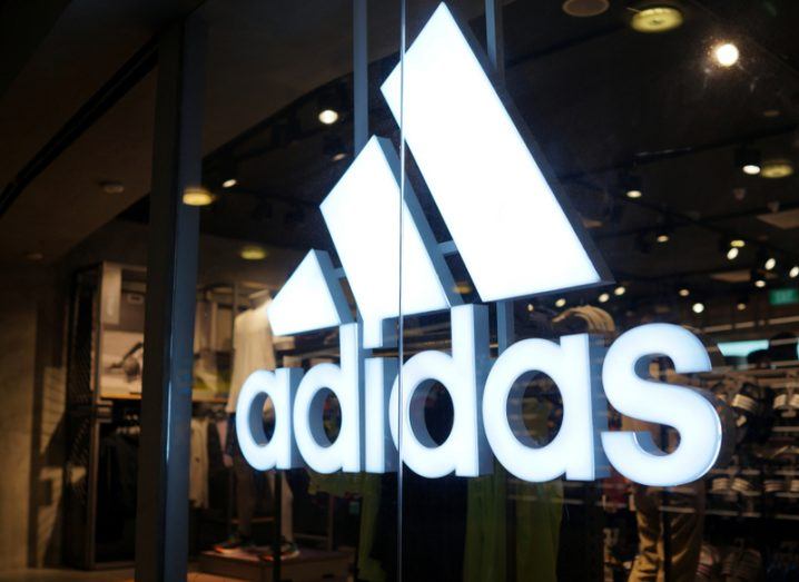 Adidas logo on front of retail store.