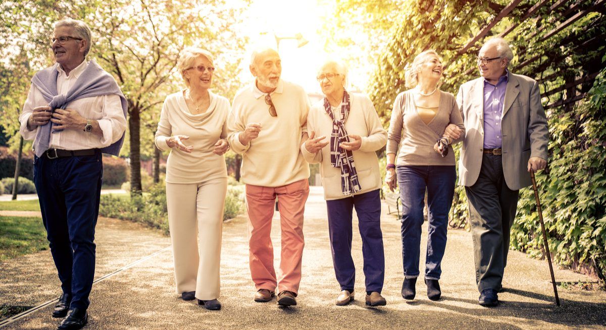 Group of old people walking outdoors. Ageing population concept