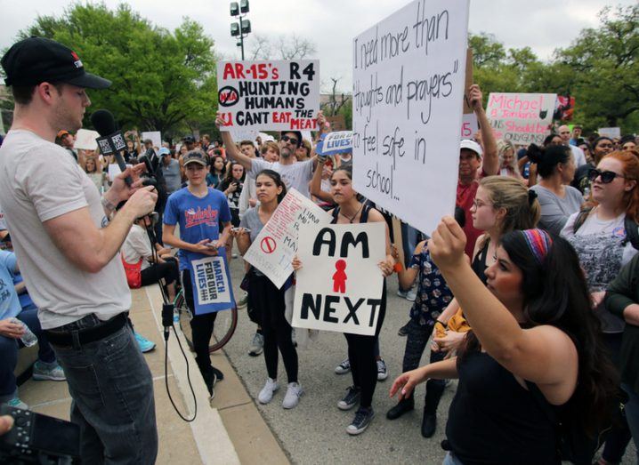 An Infowars reporter faces protestors at the March For Our Lives in Austin, Texas. InfoWars is run by Alex Jones