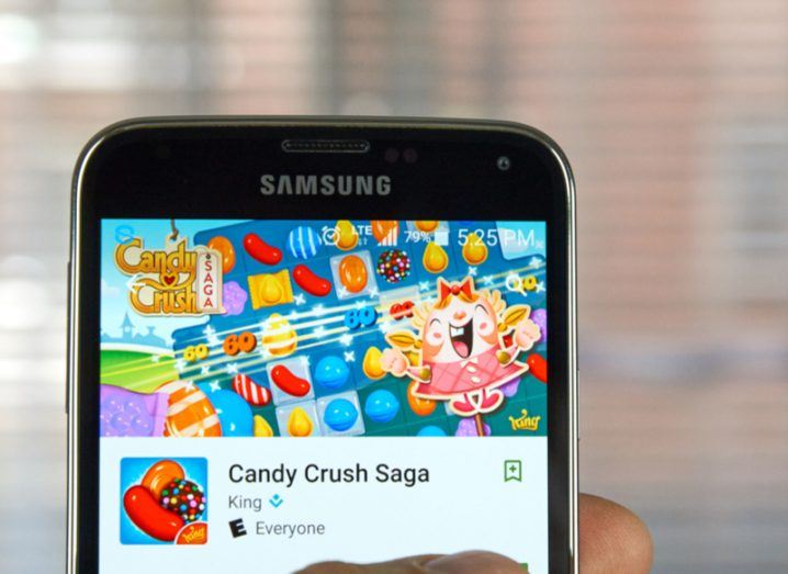 A Samsung mobile device displaying the Candy Crush Saga download screen.