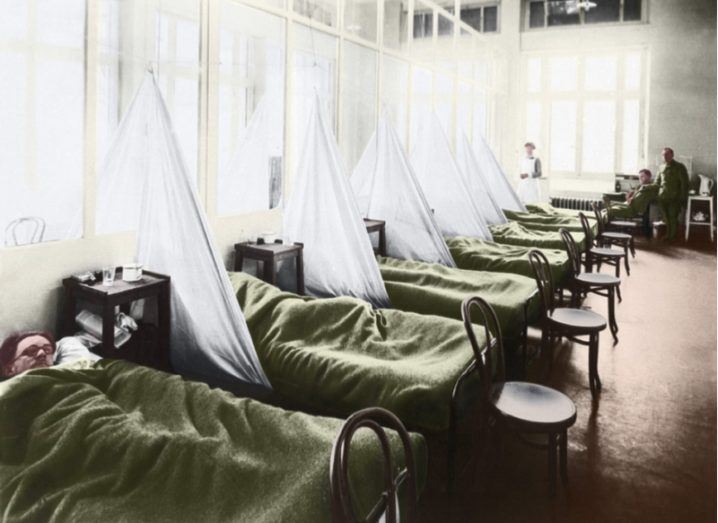 Colourised image of a group of soldiers lying in hospital beds during the 1918-1919 flu epidemic.