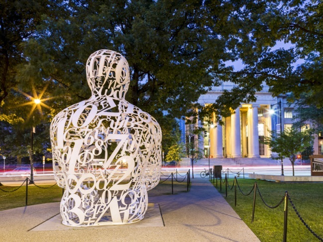 Human-like statue made of numbers sitting outside MIT campus.