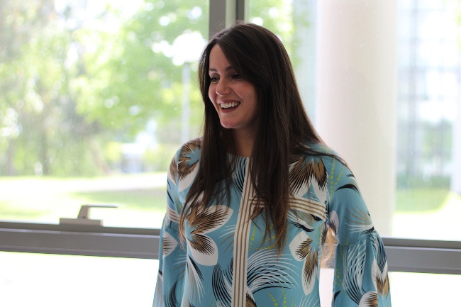 Woman with dark hair and patterned blouse.