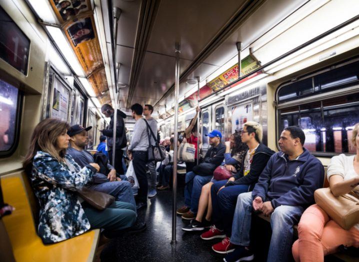 Inside a New York subway carriage full of passengers.