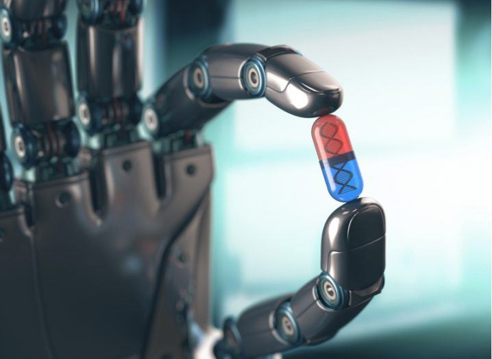 robotic hand holding red and blue pill.