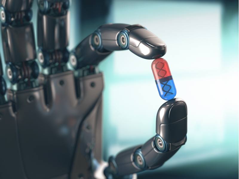 robotic hand holding red and blue pill.