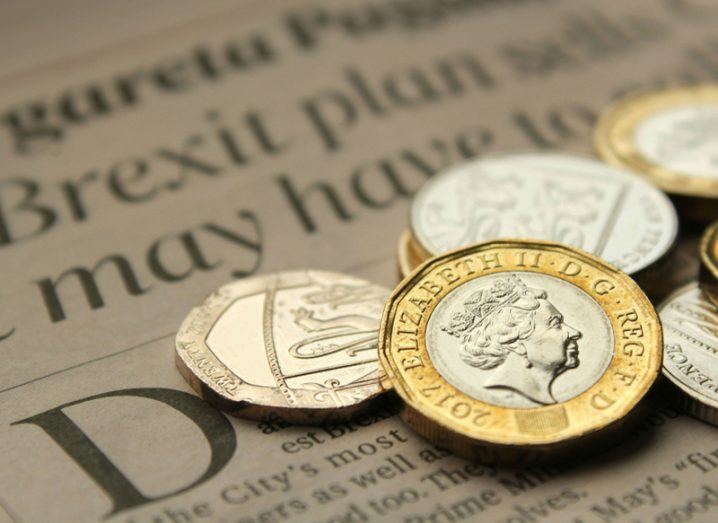 British coins on top of a newspaper with a Brexit headline.