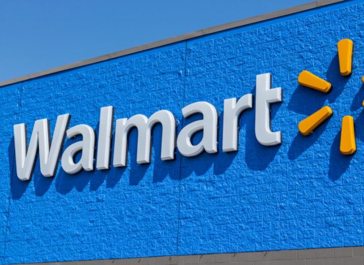 Walmart logo on a blue wall.