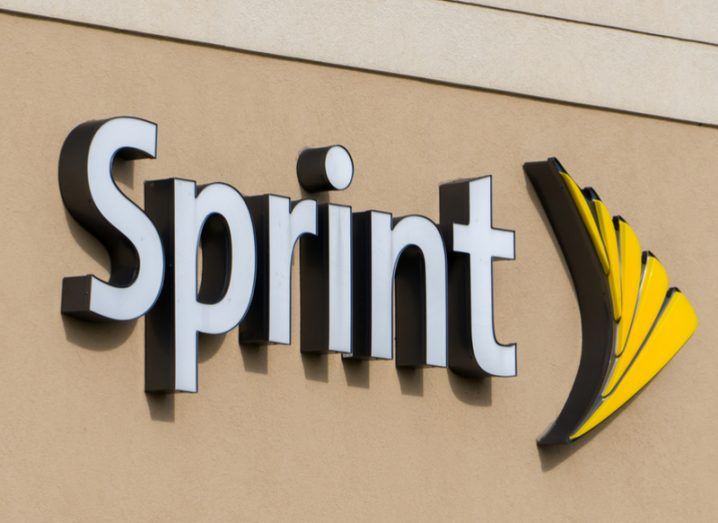 The Sprint company logo on a beige wall.