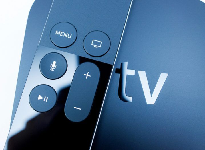 Close up of an Apple TV remote control device.
