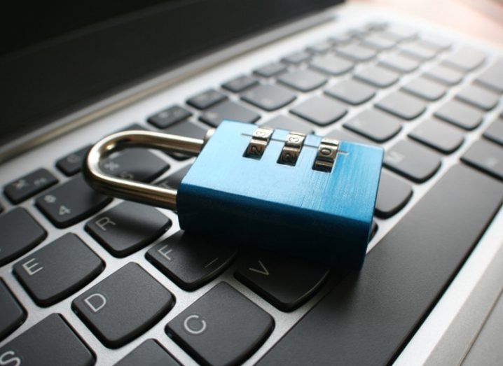 Picture of a blue lock on a computer keyboard.