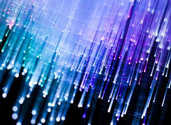 Close-up of fibre optic cables emitting blue light.