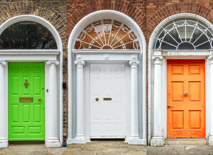 A picture of three georgian doors in dublin painted green, white and gold.