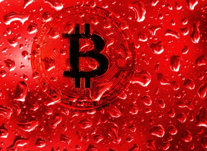 coin bitcoin behind glass with red drops.