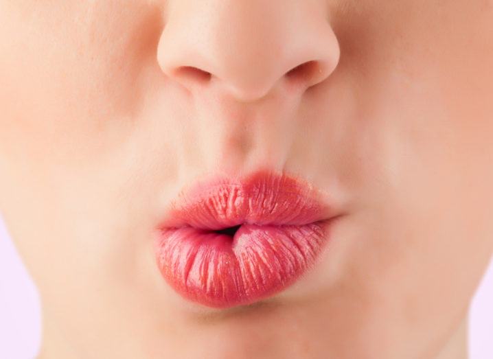 close-up of pink lips mid-speech.