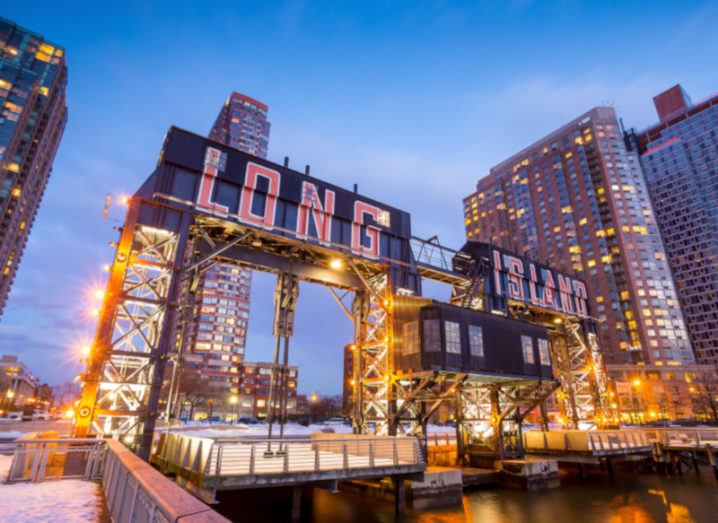 the buildings of long island in front of east river at twilight.