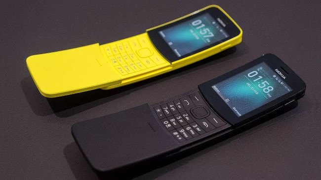 Two phones, one yellow and one black, side by side.