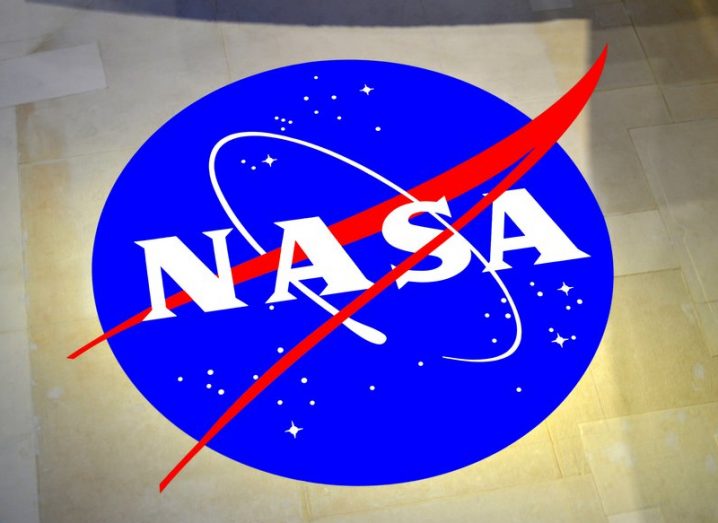 The NASA logo, a blue circle with white writing and inlaid stars.