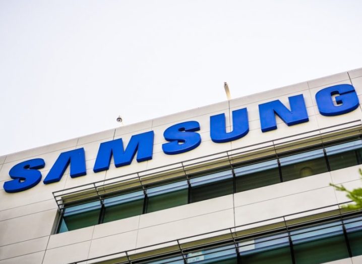 A building featuring the Samsung logo in blue with a grey sky in the background.