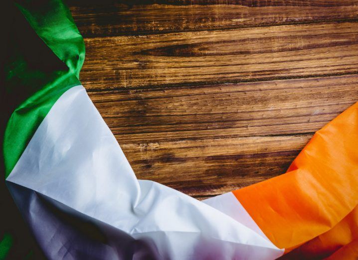 Picture of Irish flag draped across a wooden desk.
