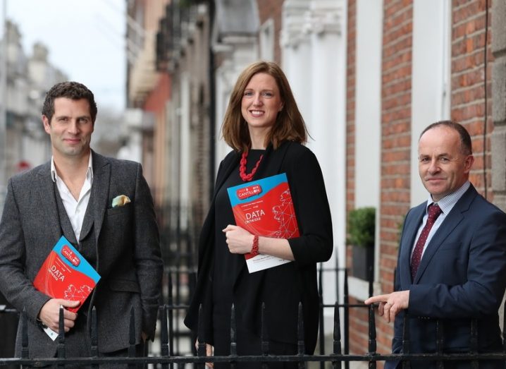 From left: Jonathan McCrea, Ruth McCarthy and Brendan O Donnell smiling with a street in the background.