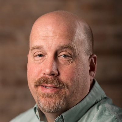 Ed Price, smiling middle-aged man with a brown beard.