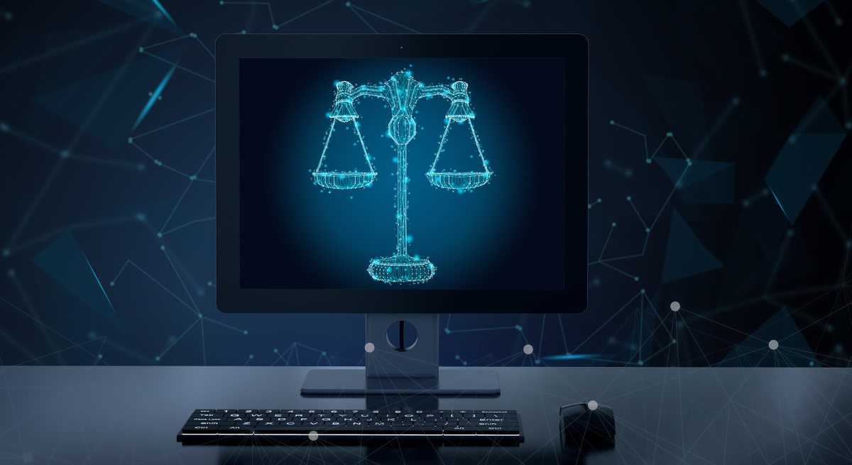 Illustration of a computer screen on a desktop displaying a digitised image of the scales of justice.