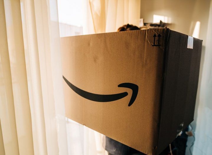 Woman holding large Amazon Prime parcel cardboard.