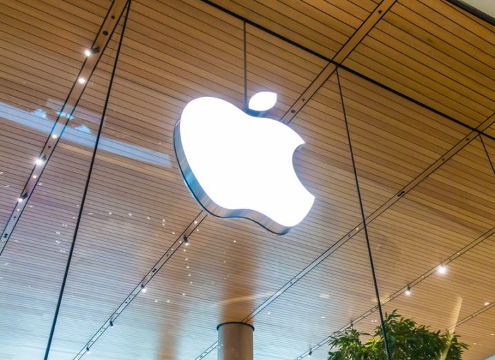 Apple logo on a glass panel, part of a retail store in Bangkok.